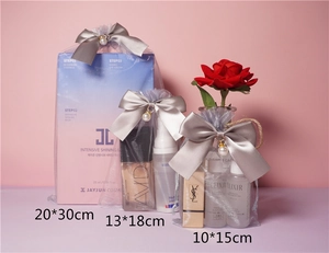 Three sizes of organza drawstring bags with pearl bow accents for cosmetic packaging