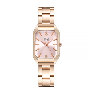 Macro detail of rose gold rectangular watch with pink dial and sparkling crystal indices