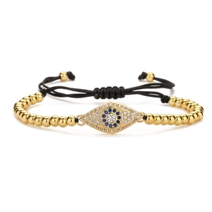 Macro detail of Evil Eye bracelet with white zircons on adjustable black woven cord