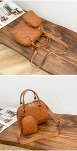 Detail of brown quilted shell bag set with gold hardware and removable shoulder strap