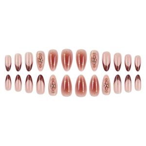 24-piece almond press-on nails with red gradient, gold stars, and oval metal accents
