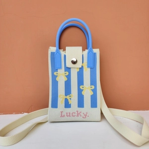 Detail of knitted mobile phone bag with blue stripes and lucky text embroidery