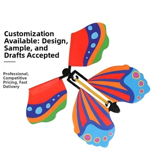 Close-up of a colorful flying butterfly toy with multi-color wings and rubber band power