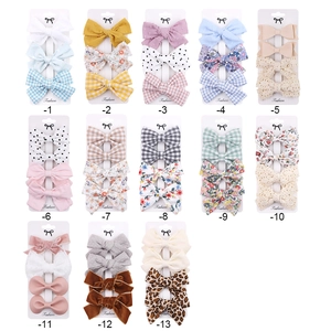 Selection of diverse fabric bow hair clips for girls featuring floral and dot patterns