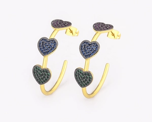 Detail of 18k gold plated C-shaped earrings with colorful zircon heart-shaped stones