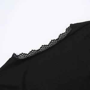 Detail of delicate black lace trim on V-neck collar of a minimalist casual women's suit