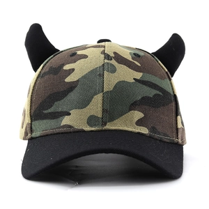 Front view of camouflage baseball cap featuring black demon horns and embroidered cross