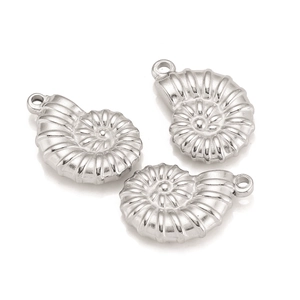 Detailed macro view of three silver stainless steel nautilus shell pendants for DIY jewelry