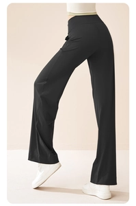 Detail of high-waist black wide-leg yoga pants showing slimming fit and fabric drape