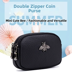 Detail of black pebbled leather coin purse with silver metal bee and double zipper closure