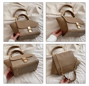 Detail view of khaki wing bag with faux crocodile pattern and matte suede texture