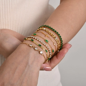 Gold layered bracelet set for women featuring emerald green stones and cubic zirconia