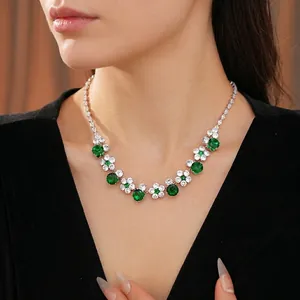 Elegant silver necklace featuring emerald green zircon flowers and round gemstones
