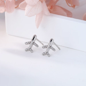 Macro view of sterling silver airplane stud earrings with micro-inlaid sparkling zircon stones