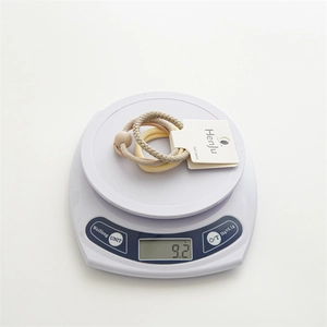 Detailed view of a 3-piece hair band set weighing 9.2g on a digital scale