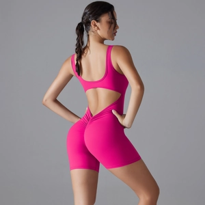 Detail of rose pink yoga bodysuit with cross back design and ruched butt lifting seam