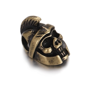 Detailed macro view of vintage bronze Spartan helmet bead with skull design for jewelry DIY
