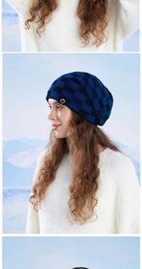 Close-up of blue and black checkered knit beanie with ear protection for winter hiking
