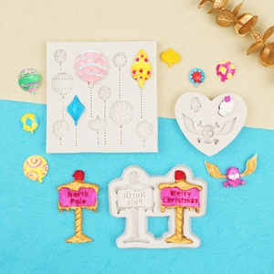 Detail of Christmas signpost and hot air balloon silicone molds with finished crafts