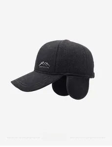 Detailed view of dark grey wool baseball cap with foldable earflaps and silver logo