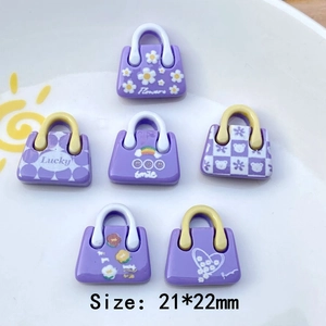 Detailed view of 6 purple resin bag charms for DIY crafts with flower and rainbow patterns