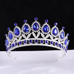 Close-up of silver bridal crown with large blue teardrop crystals and clear diamonds
