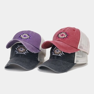 Detailed view of stacked vintage ponytail baseball caps in multiple colors and mesh