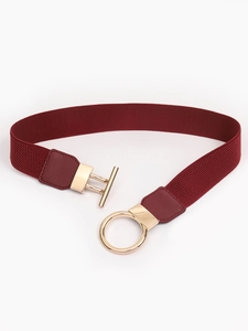 Detailed view of the burgundy elastic waist belt with a gold ring and toggle metal clasp