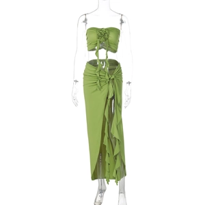 Detail of green two-piece set featuring a 3D fabric rose and ruffled slit maxi skirt