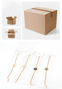 Detailed view of stainless steel initial bracelets in original branded card packaging