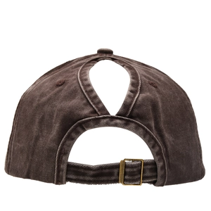Close-up of ponytail opening on washed cotton baseball cap with adjustable metal buckle
