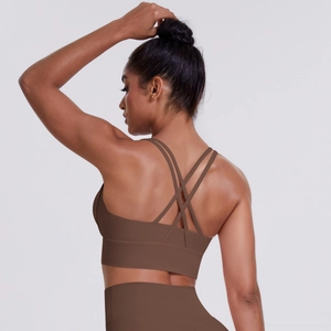 Close-up of brown cross back sports bra with thin straps and matte yoga fabric