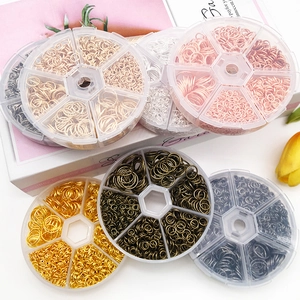 Top view of assorted sizes of colorful metal jump rings in a plastic storage case