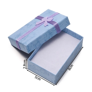 Blue rectangular jewelry gift box with purple ribbon, dimensions 8x5x2.8 cm detail view