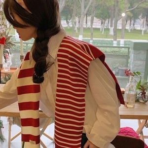 Detail of red and white striped knit shawl on white shirt with F&R Handmade label