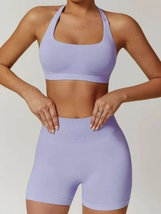 Detail view of the ribbed waistband on lavender yoga shorts and halter sports bra