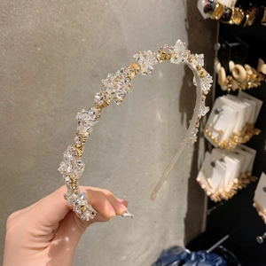 Detail of luxury crystal beaded headband with gold claw settings and silicone end caps