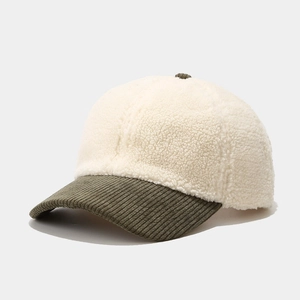 Detail of lamb wool baseball cap with contrast corduroy brim and plush texture