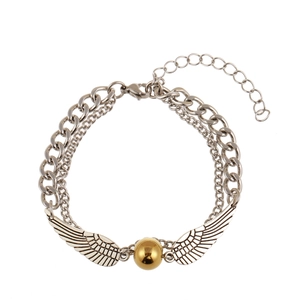 Detail of silver double-layer chain bracelet featuring golden snitch wing pendant