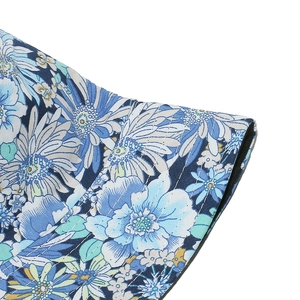Close-up of blue floral sun hat showing high-density white reinforcement stitching detail