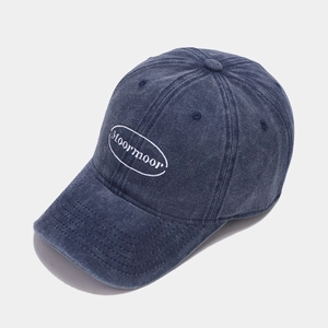 Close-up of vintage washed navy cotton baseball cap with white Moormoor embroidery