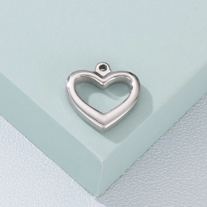 Detailed close-up of a silver polished hollow heart pendant on a light blue background