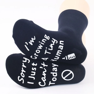 Close-up of black cotton socks with anti-slip white lettering on the bottom