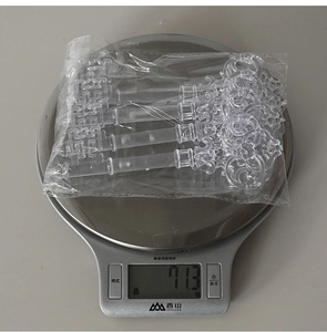 Detailed view of vintage acrylic key ornaments on a digital scale showing weight of 71.3g