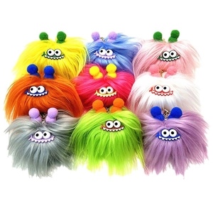 Colorful set of fuzzy monster plush keychains with cartoon eyes and jagged mouths