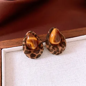Retro resin leopard print teardrop earrings on a textured display tray in warm tones