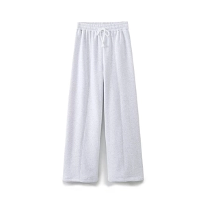 Detail of light gray wide-leg joggers with drawstring waist and central seam stitching