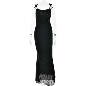 Detail of black backless dress showing 3D bow straps and pleated mesh fabric texture
