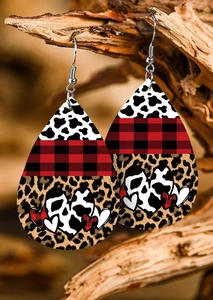 Macro shot of teardrop faux leather earrings with red plaid and cow print textures