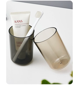 Close-up of dual translucent minimalist mouthwash cups in grey and light brown tones